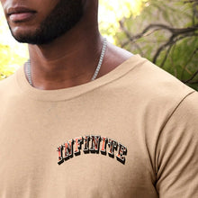 Load image into Gallery viewer, "INFINTIE VICTORY THROUGH JESUS CHRIST" TEE | FRONT CORNER ARCH + BACK (SAND)